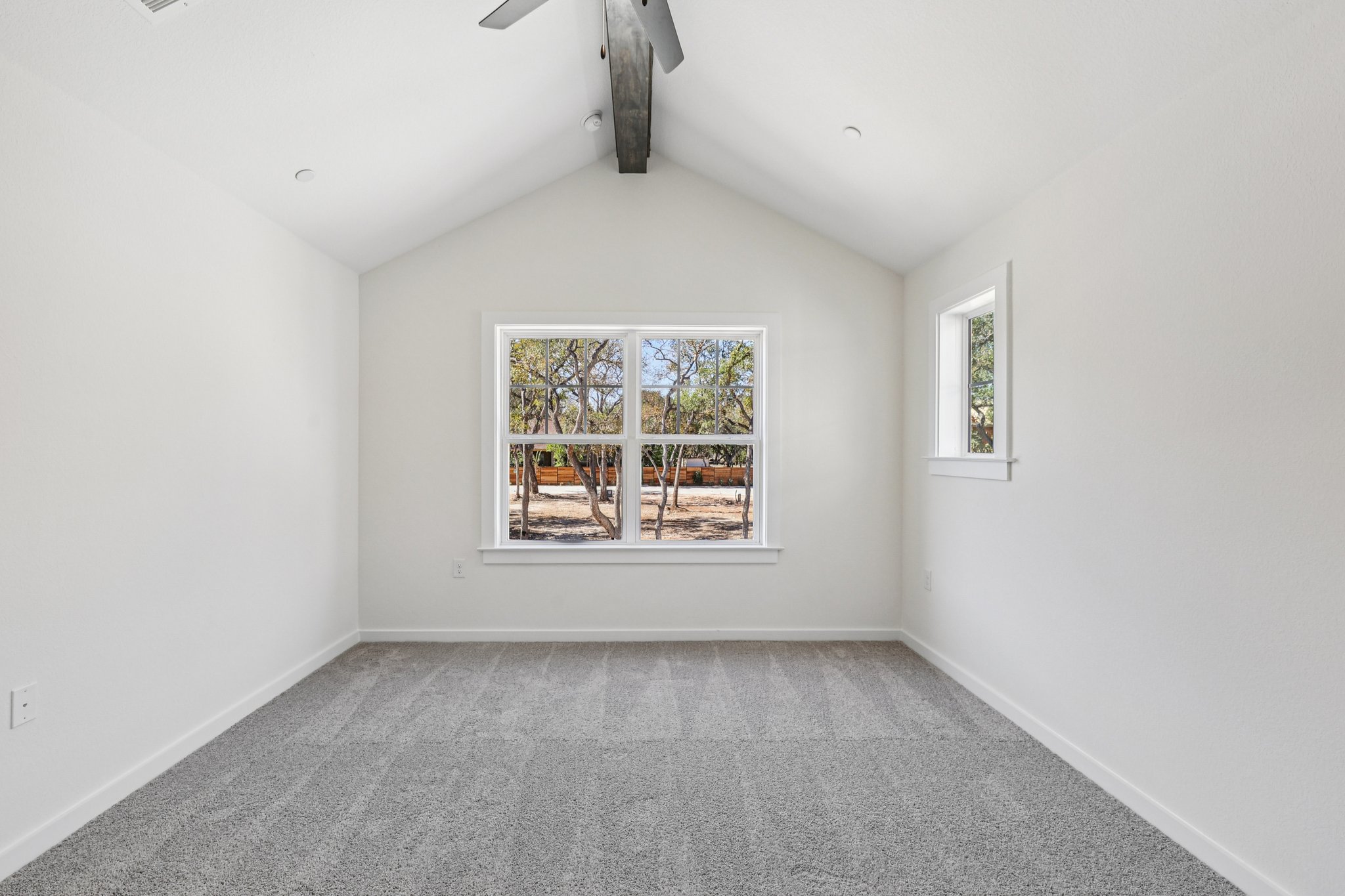 2414 Drew Lane, Unit 3 Austin, TX 78748 - Photo 14 of 18 Spare room with light carpet, beam ceiling, and a ceiling fan
