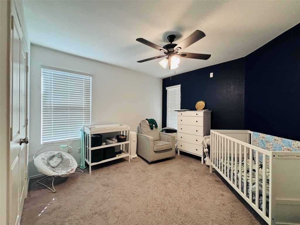 113 Star Pass Jarrell, TX 76537 - Photo 14 of 18 a bedroom with furniture and a chandelier