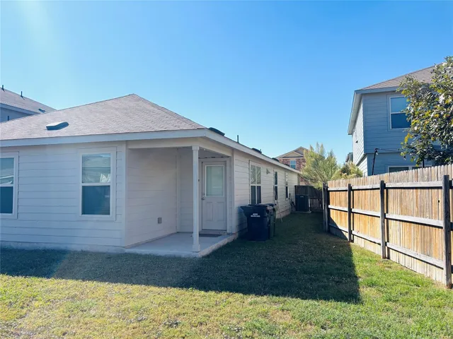 a view of a house with a wooden fence
