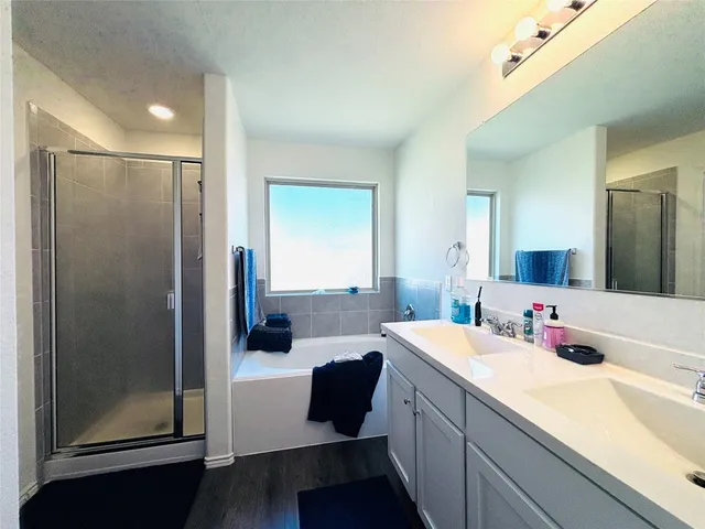 a bedroom with bed and white cabinets