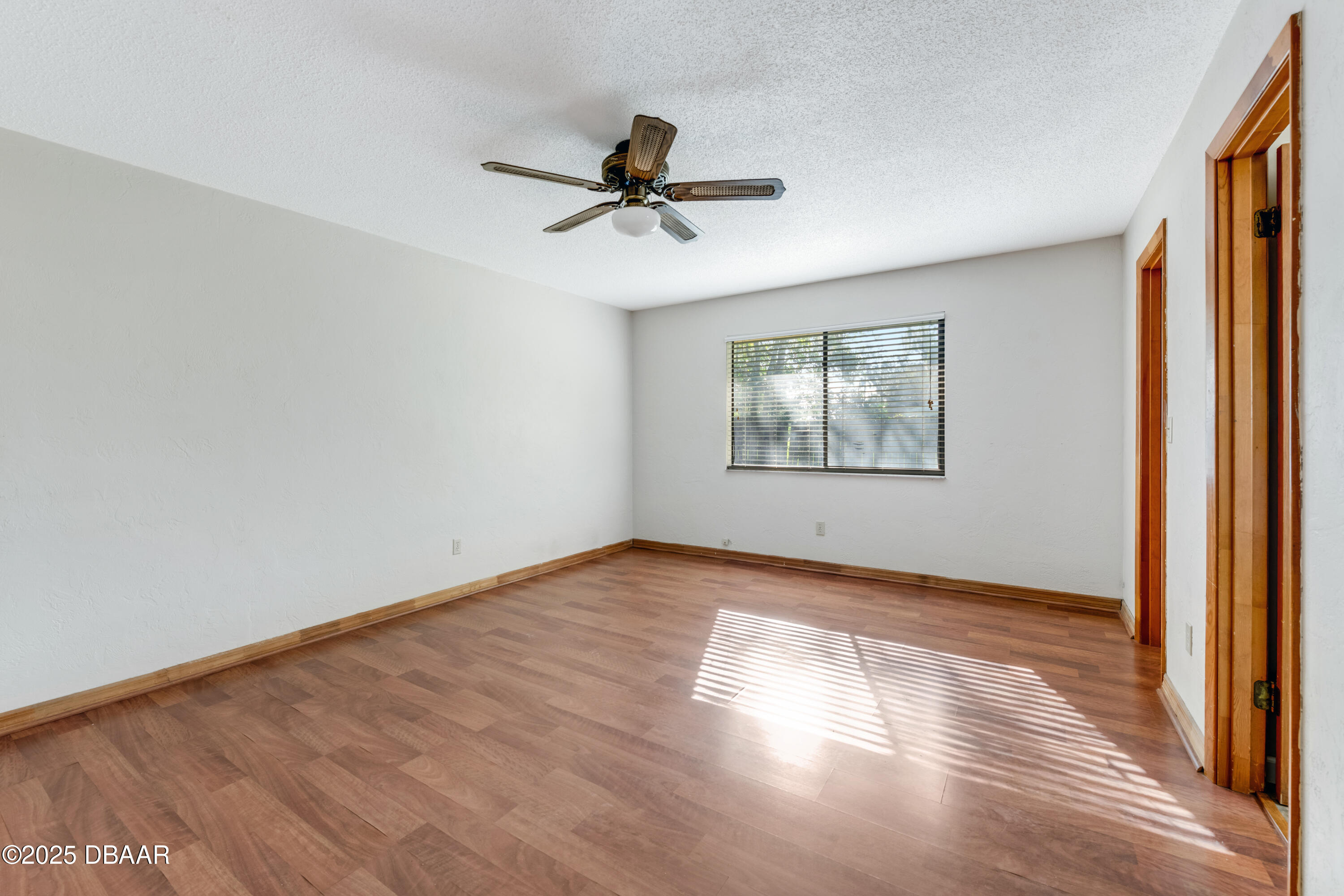 500 Sandy Oaks Boulevard Ormond Beach, FL 32174 - Photo 13 of 31 wooden floor in an empty room with a window