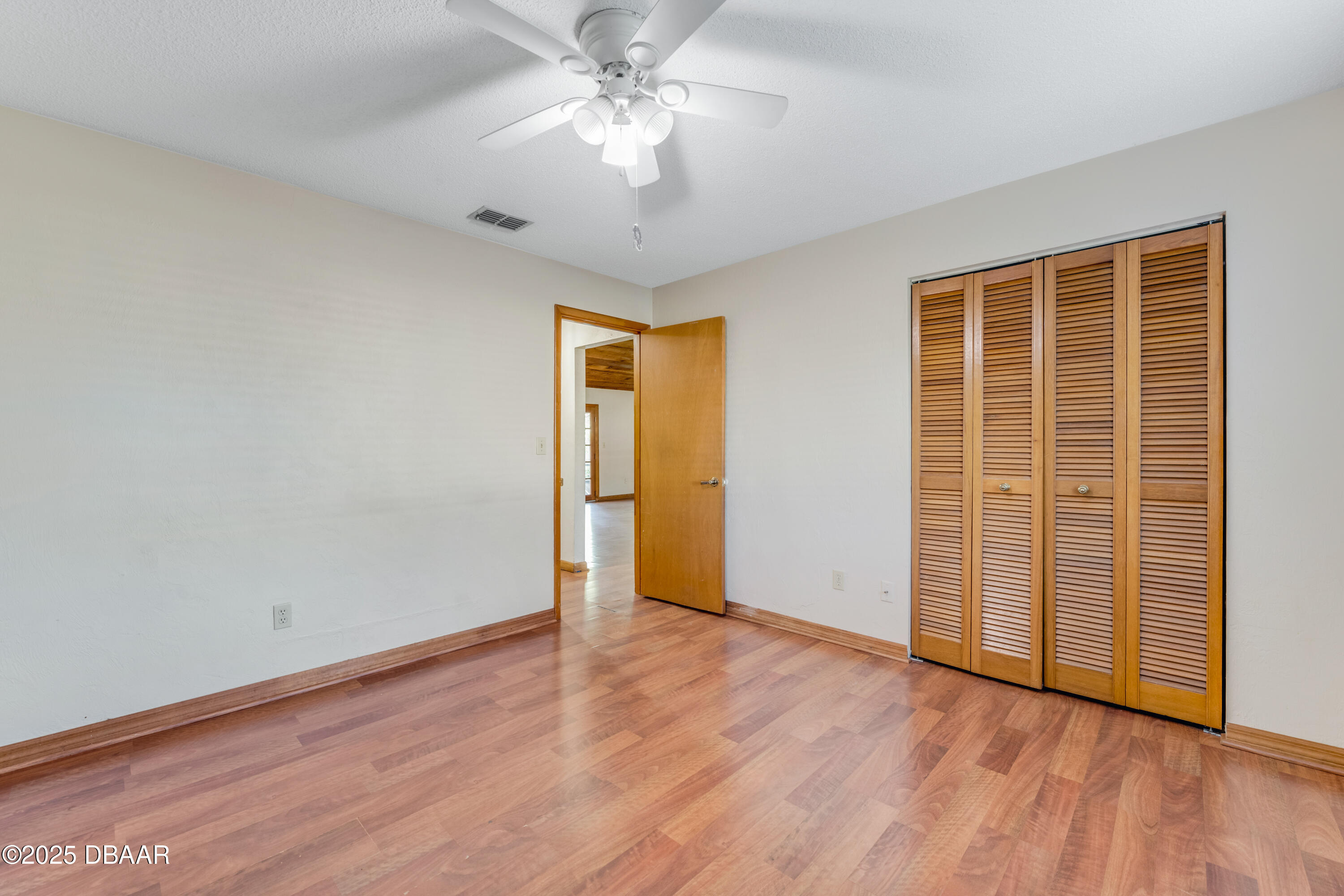 500 Sandy Oaks Boulevard Ormond Beach, FL 32174 - Photo 18 of 31 an empty room with wooden floor closet and windows
