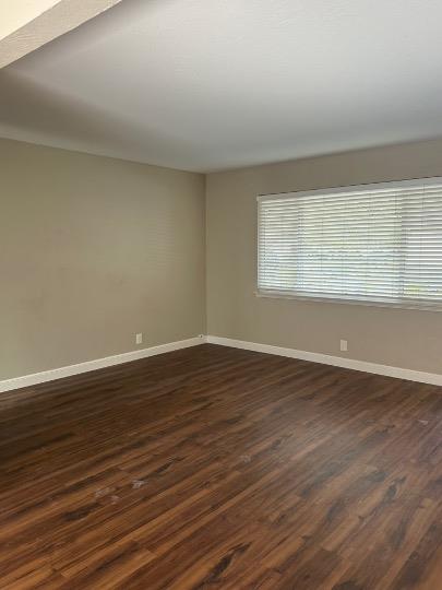 531 Piazza Drive, Unit A Mountain View, CA 94043 - Photo 9 of 15 a view of an empty room with wooden floor and a window