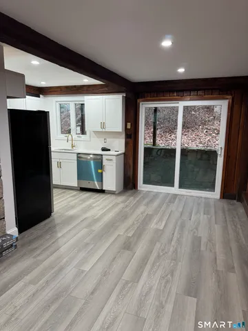 a open kitchen with a sink a refrigerator and window