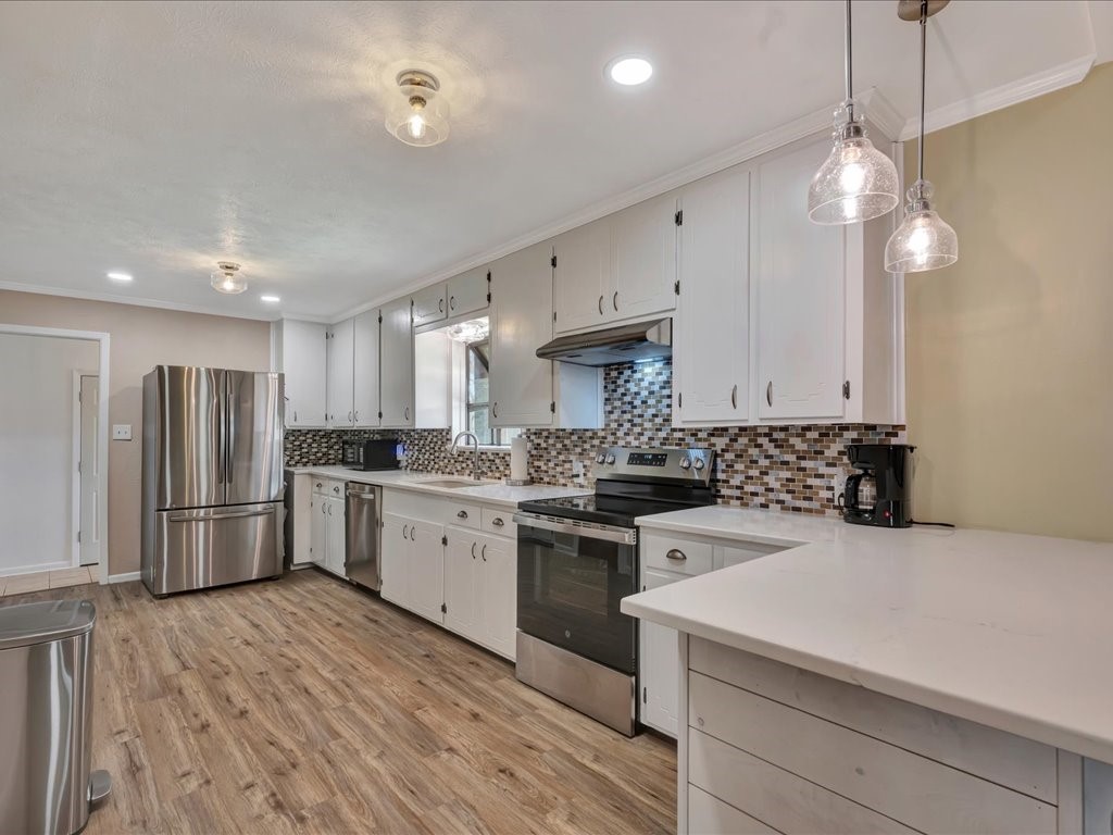 1013 Dewitt Hinson Road Pollok, TX 75969 - Photo 11 of 33 a kitchen with a sink a stove a refrigerator and white cabinets