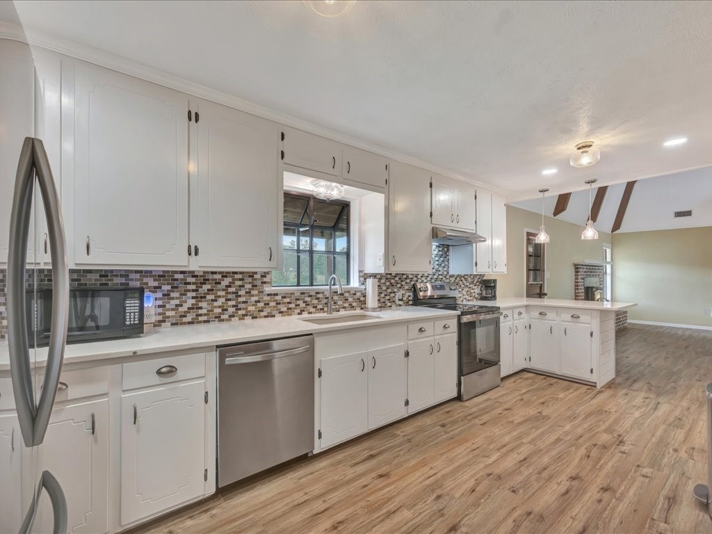 1013 Dewitt Hinson Road Pollok, TX 75969 - Photo 12 of 33 a kitchen with granite countertop white cabinets and white appliances