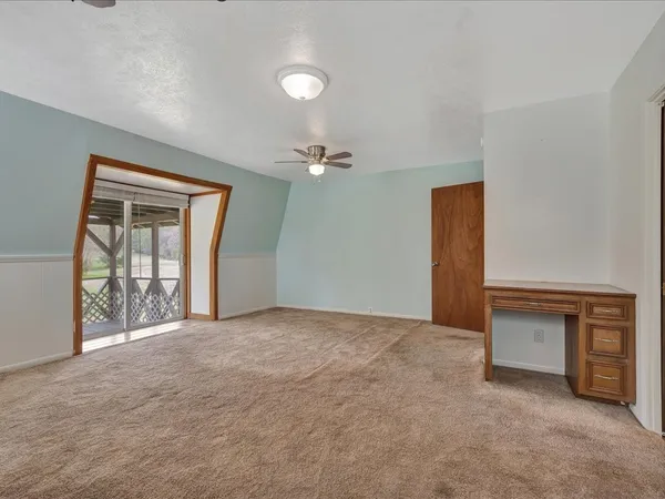 an empty room with windows and closet