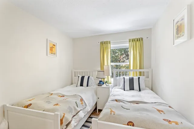 a bedroom with a bed and a large window