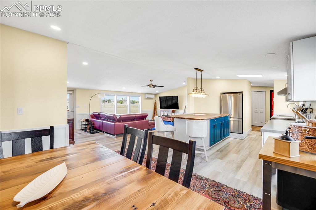 5865 East Blaney Road Peyton, CO 80831 - Photo 13 of 49 a living room with chairs kitchen view and a wooden floor