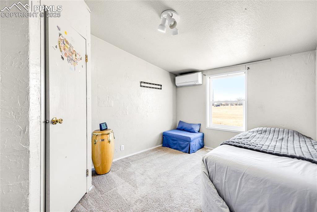 5865 East Blaney Road Peyton, CO 80831 - Photo 27 of 49 a bedroom with a bed and a window