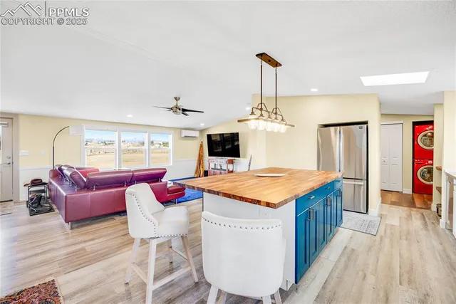 a open kitchen with stainless steel appliances granite countertop a stove and kitchen island