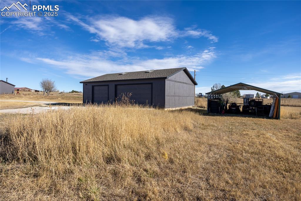 5865 East Blaney Road Peyton, CO 80831 - Photo 39 of 49 a car parked in front of a house with a yard