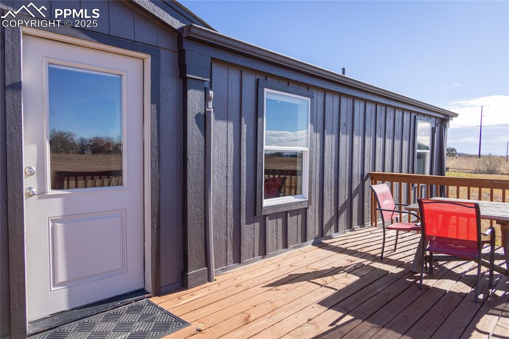 5865 East Blaney Road Peyton, CO 80831 - Photo 42 of 49 a balcony with table and chairs