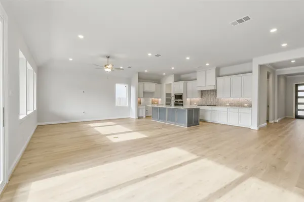 a kitchen with stainless steel appliances granite countertop a sink a stove a refrigerator and a oven