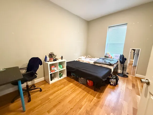 a bed room with a bed and a chair