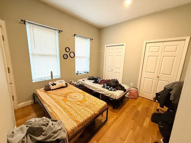 a bedroom with two beds and a dresser