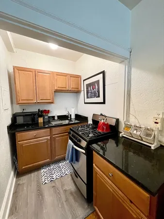 a kitchen with stainless steel appliances granite countertop a sink stove and granite counter top
