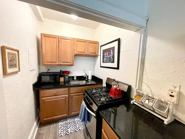 a kitchen with a sink stove and cabinets