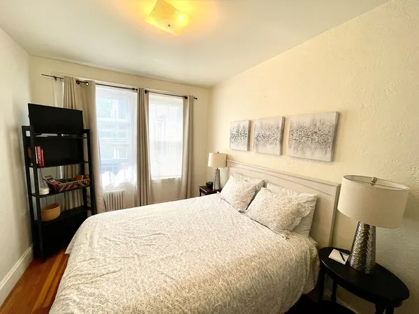 a bedroom with a bed and a mirror