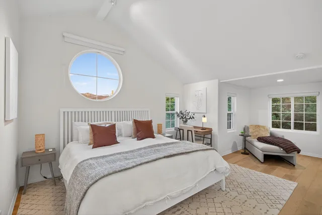 a bedroom with bed and a window