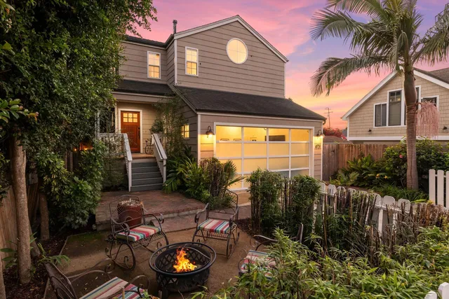 a backyard of a house with yard fountain and outdoor seating