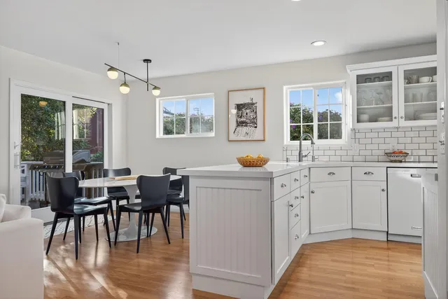a kitchen with cabinets table and chairs