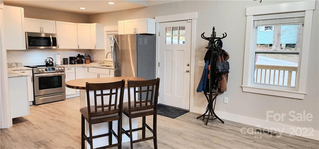 90 Ash Drive Maggie Valley, NC 28751 - Photo 11 of 27 a view of kitchen with refrigerator and wooden floor