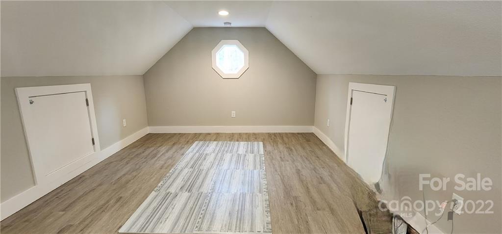 90 Ash Drive Maggie Valley, NC 28751 - Photo 16 of 27 an empty room with wooden floor and windows