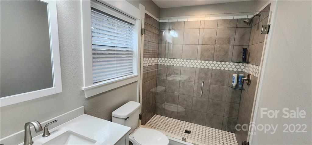 90 Ash Drive Maggie Valley, NC 28751 - Photo 21 of 27 a bathroom with a toilet and a shower