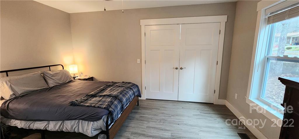 90 Ash Drive Maggie Valley, NC 28751 - Photo 22 of 27 a bedroom with a bed and a flat screen tv