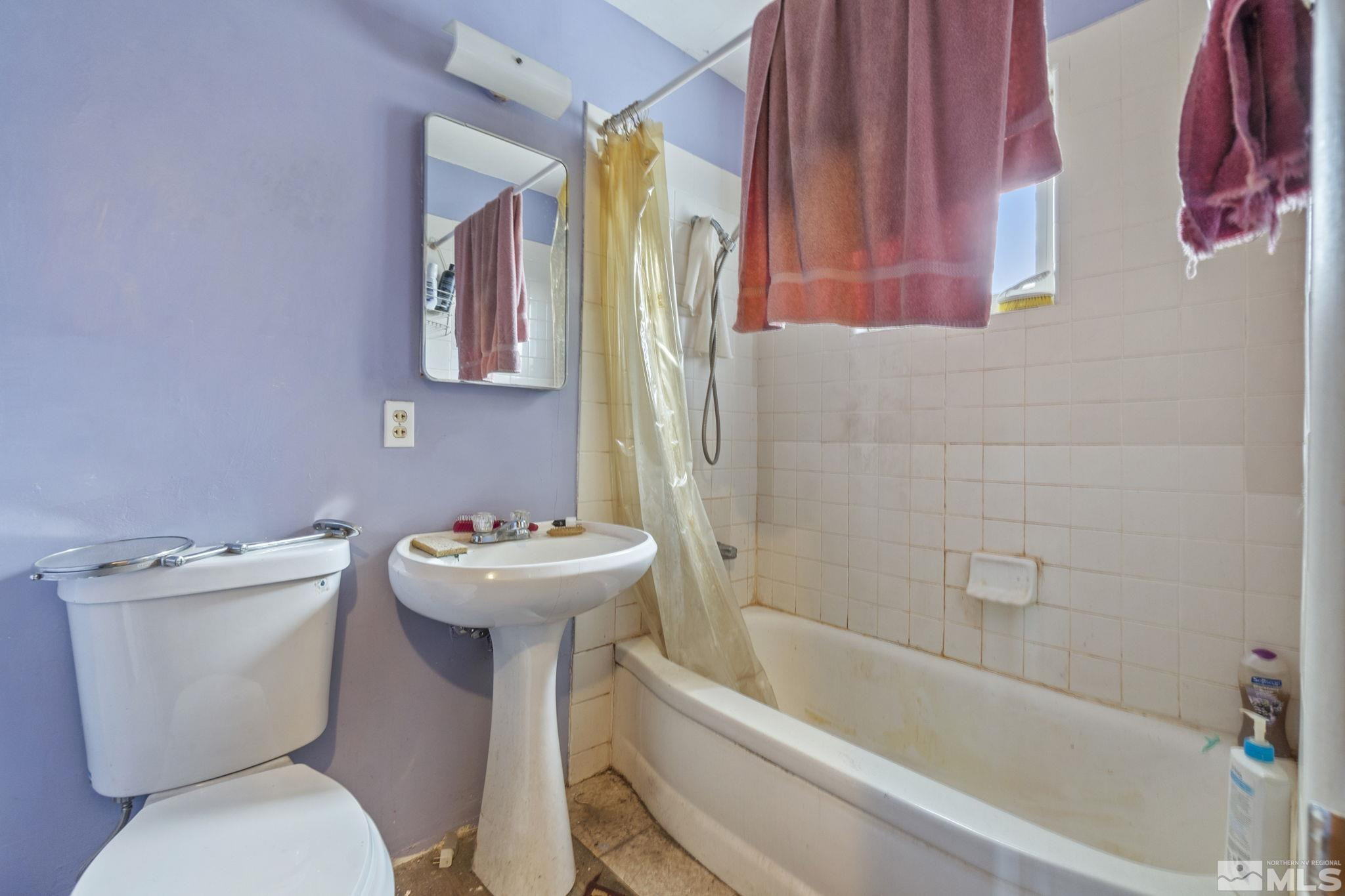 796-798 Moran Street Reno, NV 89502 - Photo 10 of 11 a bathroom with a sink mirror bathtub and toilet