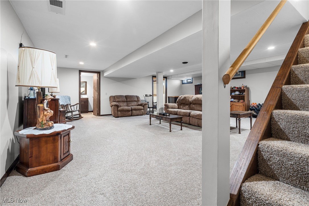 1521 Bravado Road Southwest Canton, OH 44706 - Photo 17 of 37 Living area featuring light carpet, stairs, and recessed lighting