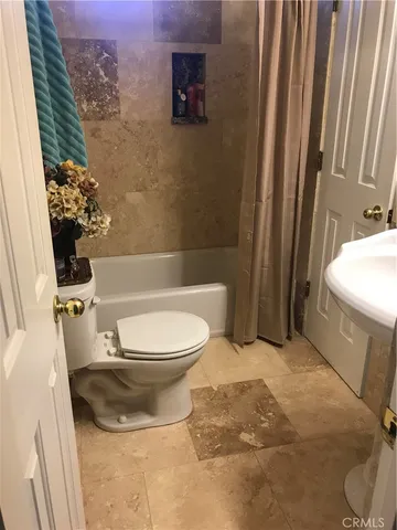 a bed sitting in a bedroom next to a lamp