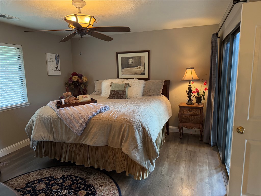40820 Oak Ridge Drive Three Rivers, CA 93271 - Photo 24 of 65 a bedroom with a bed and a chandelier