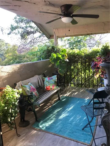 a view of a balcony with chair and potted plants