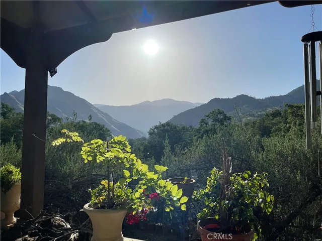 a view of a yard with wooden fence