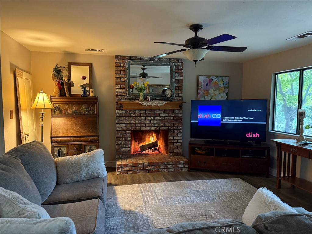 40820 Oak Ridge Drive Three Rivers, CA 93271 - Photo 5 of 65 a living room with furniture a flat screen tv and a fireplace