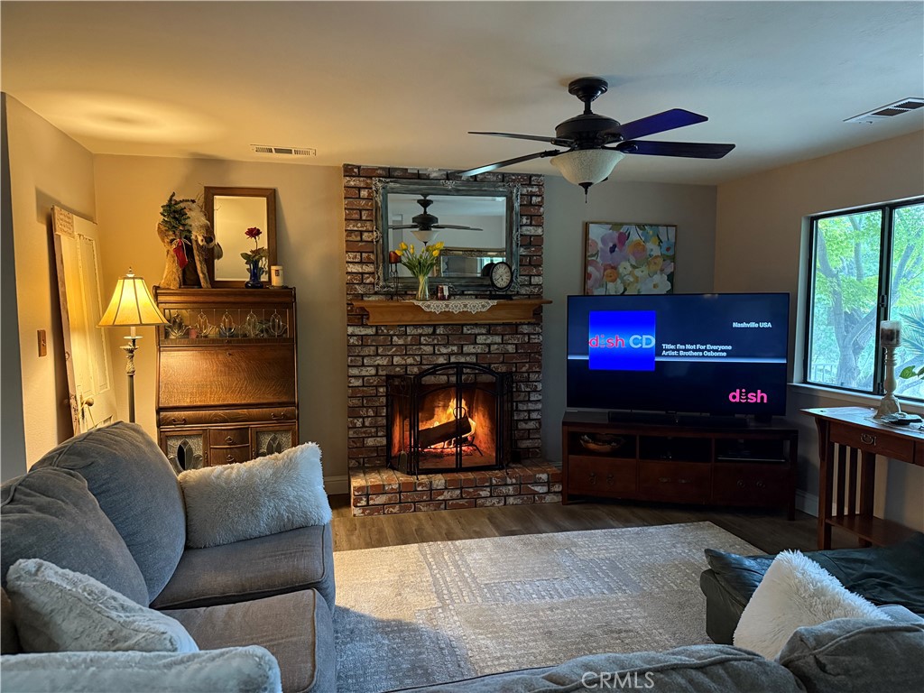 40820 Oak Ridge Drive Three Rivers, CA 93271 - Photo 6 of 65 a living room with furniture a flat screen tv and a fireplace