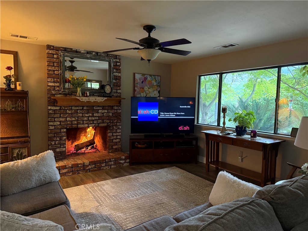 40820 Oak Ridge Drive Three Rivers, CA 93271 - Photo 7 of 65 a living room with furniture a flat screen tv and a fireplace