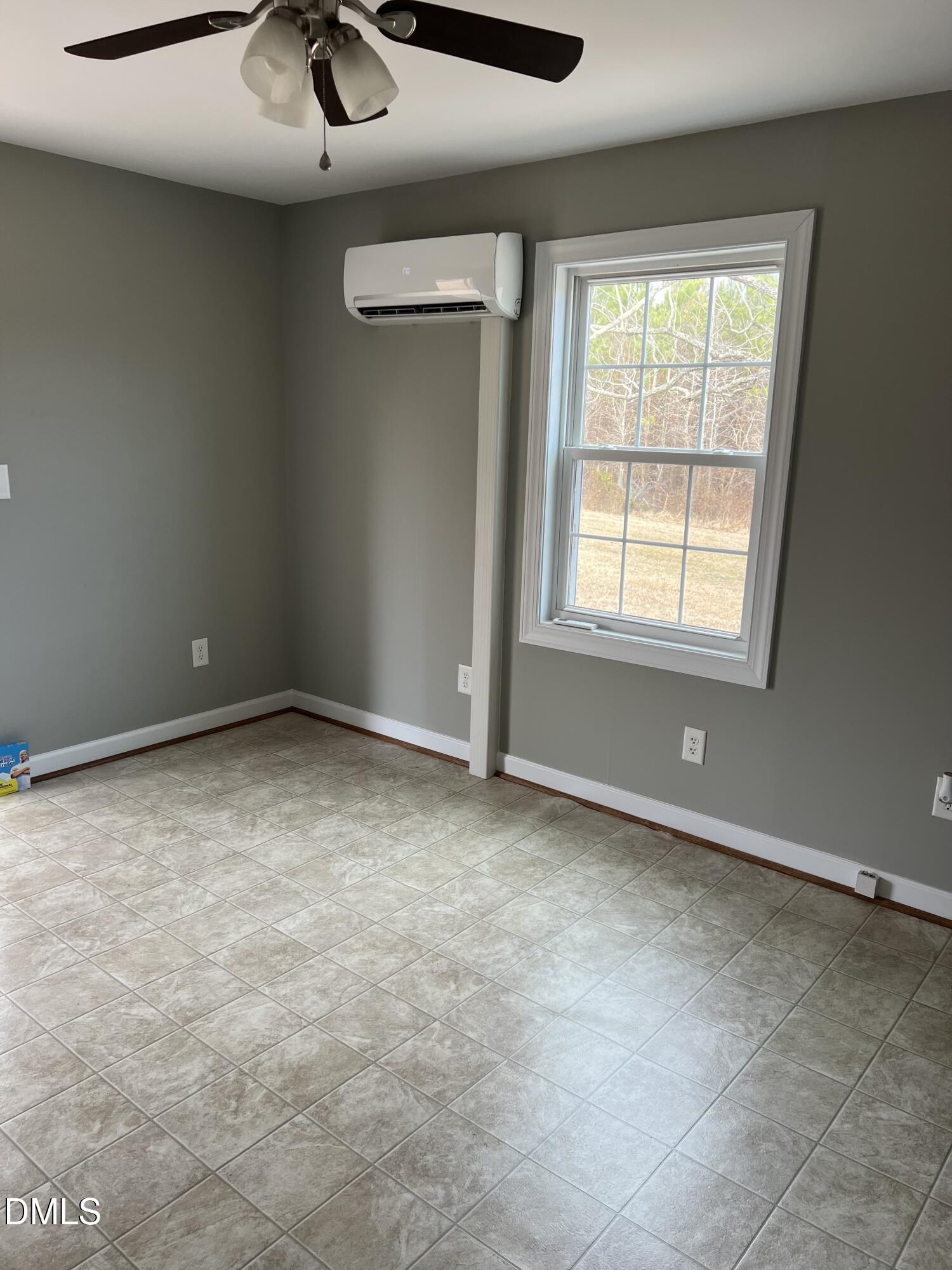 317 Brewer Road Louisburg, NC 27549 - Photo 12 of 14 an empty room with a ceiling fan and window