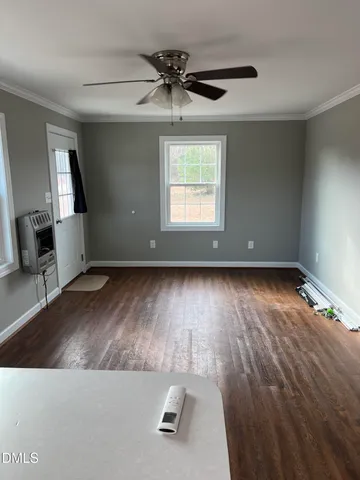 wooden floor in an empty room with a window
