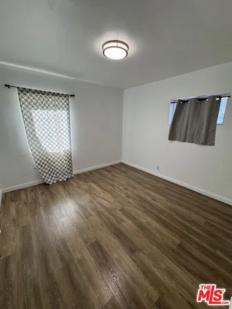 a view of an empty room and wooden floor