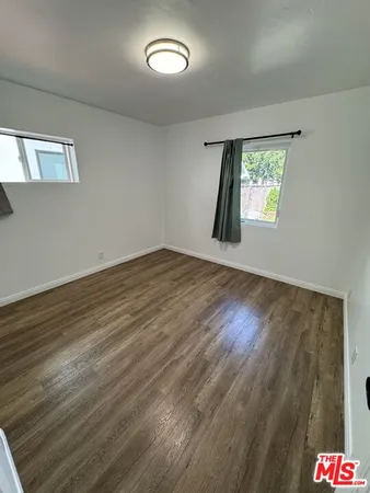 a large kitchen with a counter space a sink appliances and cabinets