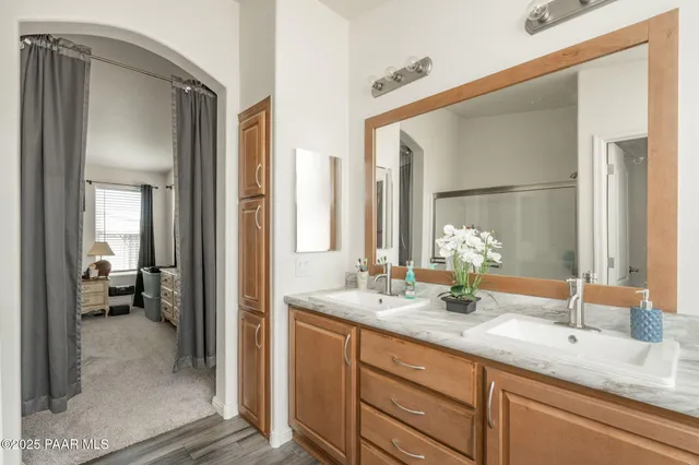 a bathroom with a double vanity sink and a mirror