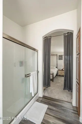a view of a bathroom with a shower and a mirror