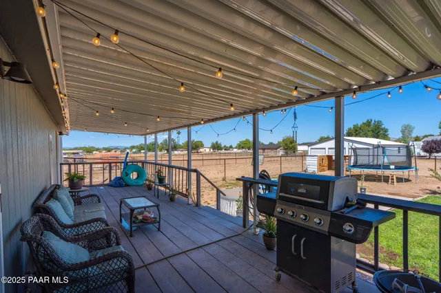 a view of house with swimming pool and furniture
