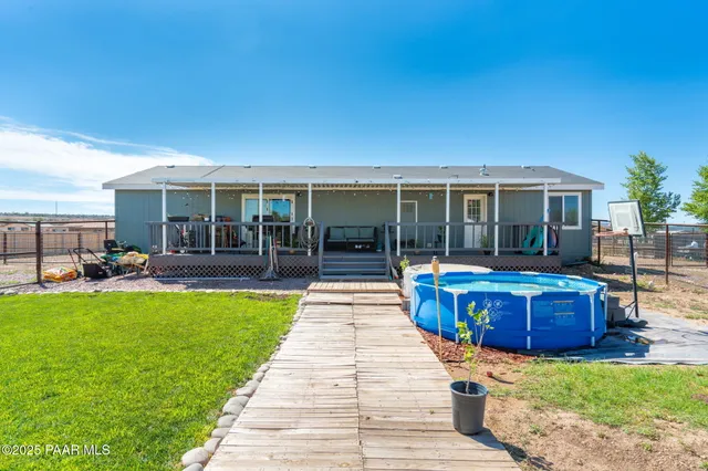 a view of a house with swimming pool and a garden