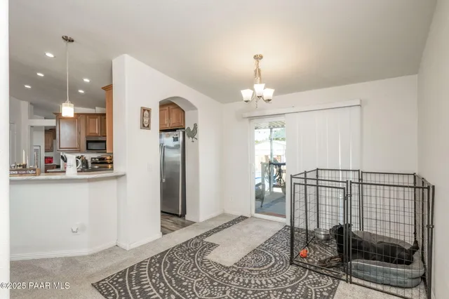 a view of a hallway with dining area
