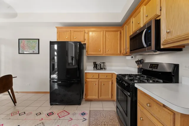 a kitchen with stainless steel appliances granite countertop a refrigerator stove and sink
