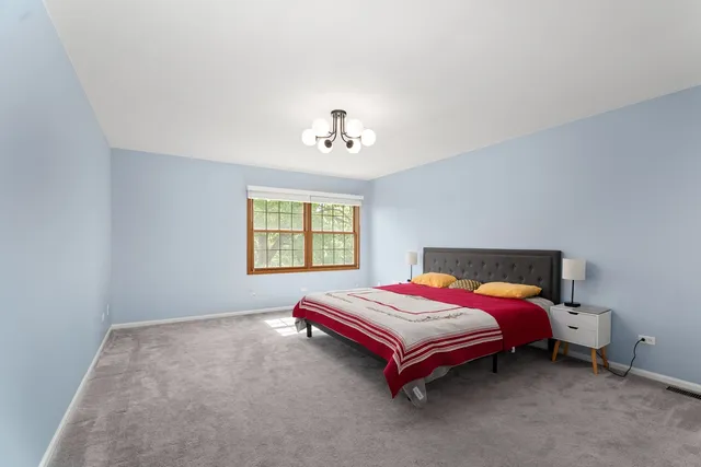 a bed room with a bed and a window